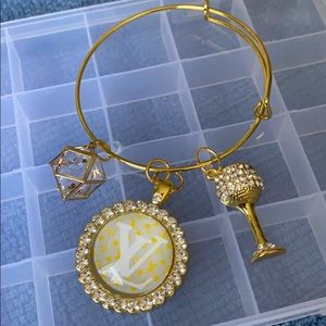 Gold plated bangle with charms